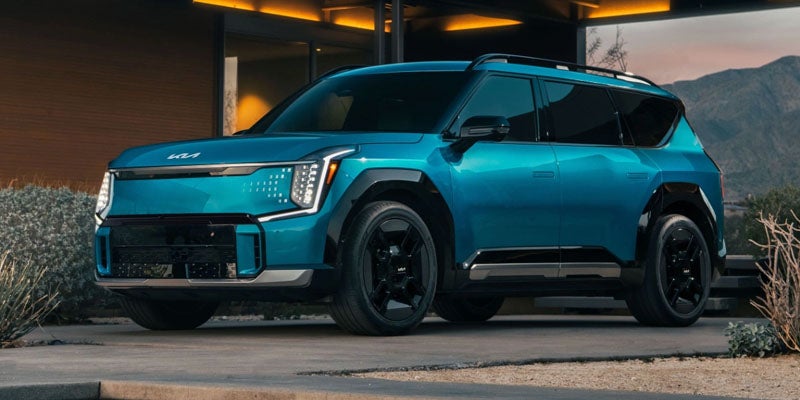 A 2024 Kia EV9 parked outside a stylish house in New Port Richey, FL