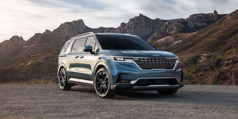 A 2024 Kia Carnival parked outside near a picturesque roadside stop during a family vacation near New Port Richey, FL 