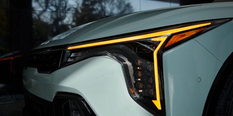A close-up view of the headlights of the 2025 Kia K4 in New Port Richey, FL
