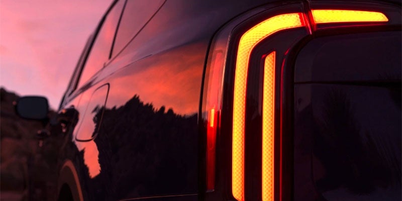 A beautiful sunset view of the taillights of the 2025 Kia Telluride in New Port Richey, FL