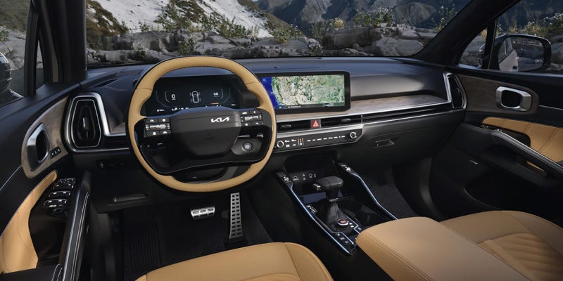 Interior of a car with a two-tone steering wheel, digital dashboard, and wide infotainment screen displaying a map
