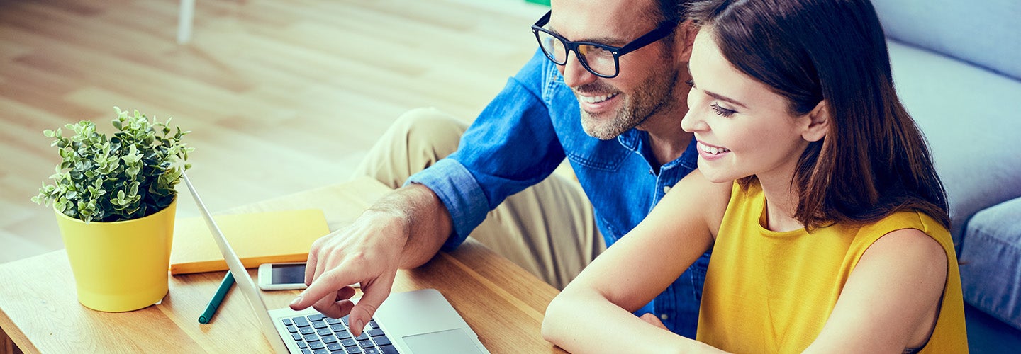 Happy couple browsing online